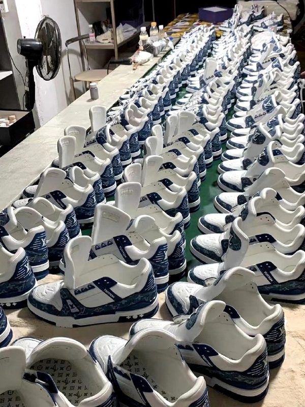 Sneaker batch production line — uniform pairs aligned post-assembly for inspection